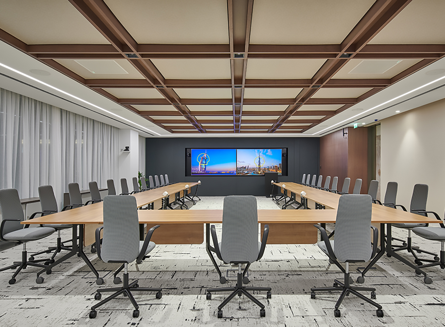 The versatile boardroom features foldable tables, adaptable for various meeting setups from U-shaped to training configurations. 