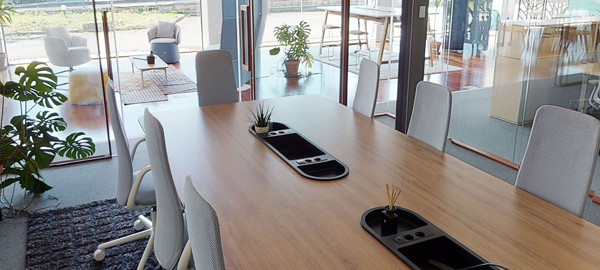 Nia chairs at an Immerse conference table within a glass walled space offers a private meeting room for up to ten people.