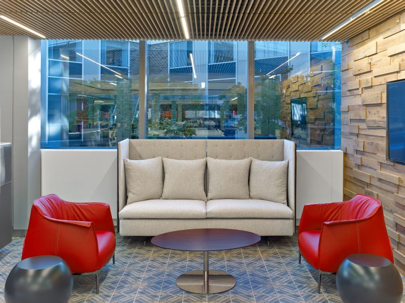 Haworth Archibald lounge chair in red leather with grey couch by the window