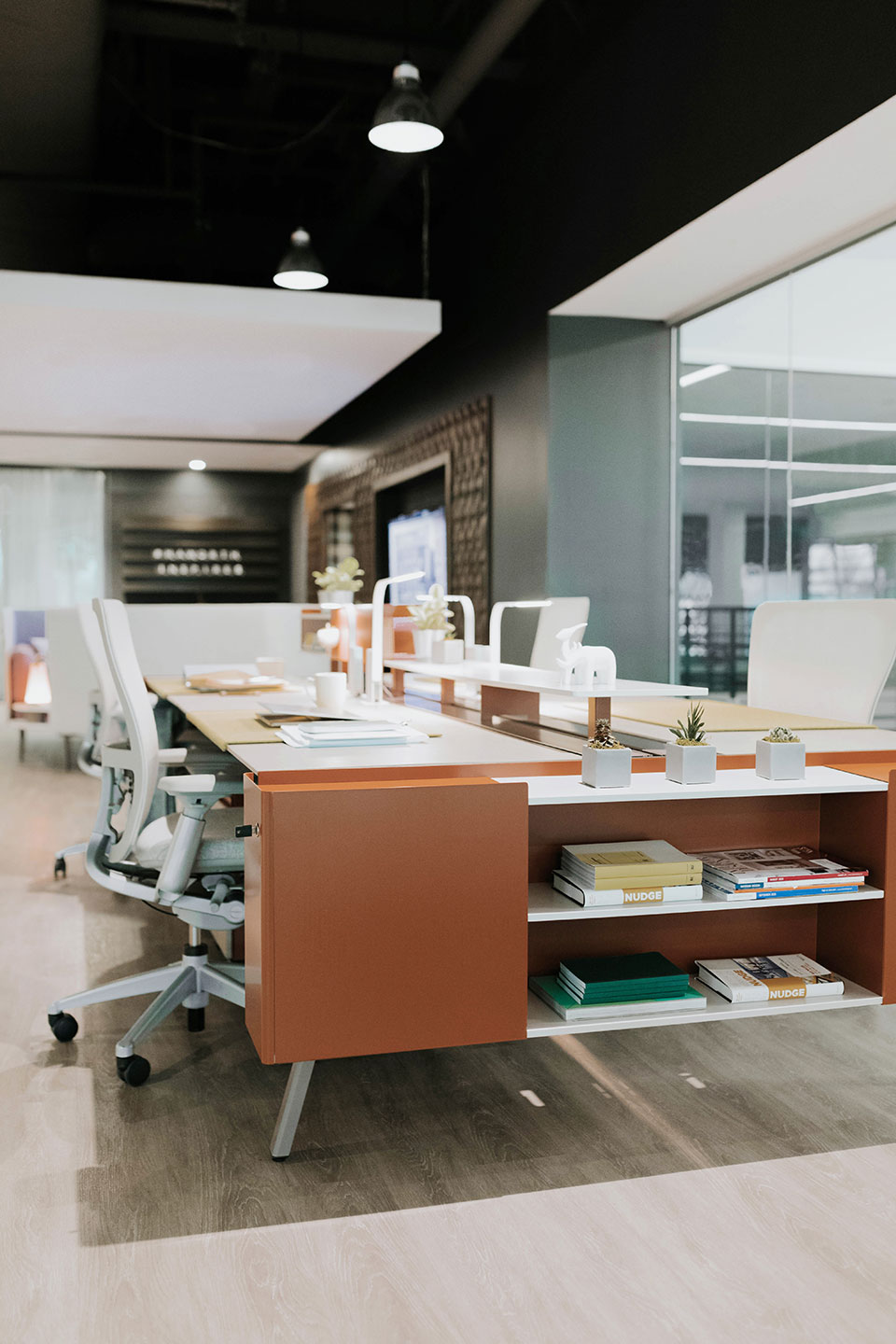 Haworth Intuity Workspace divider in open office space with compartment for storage next to desks and Haworth lights