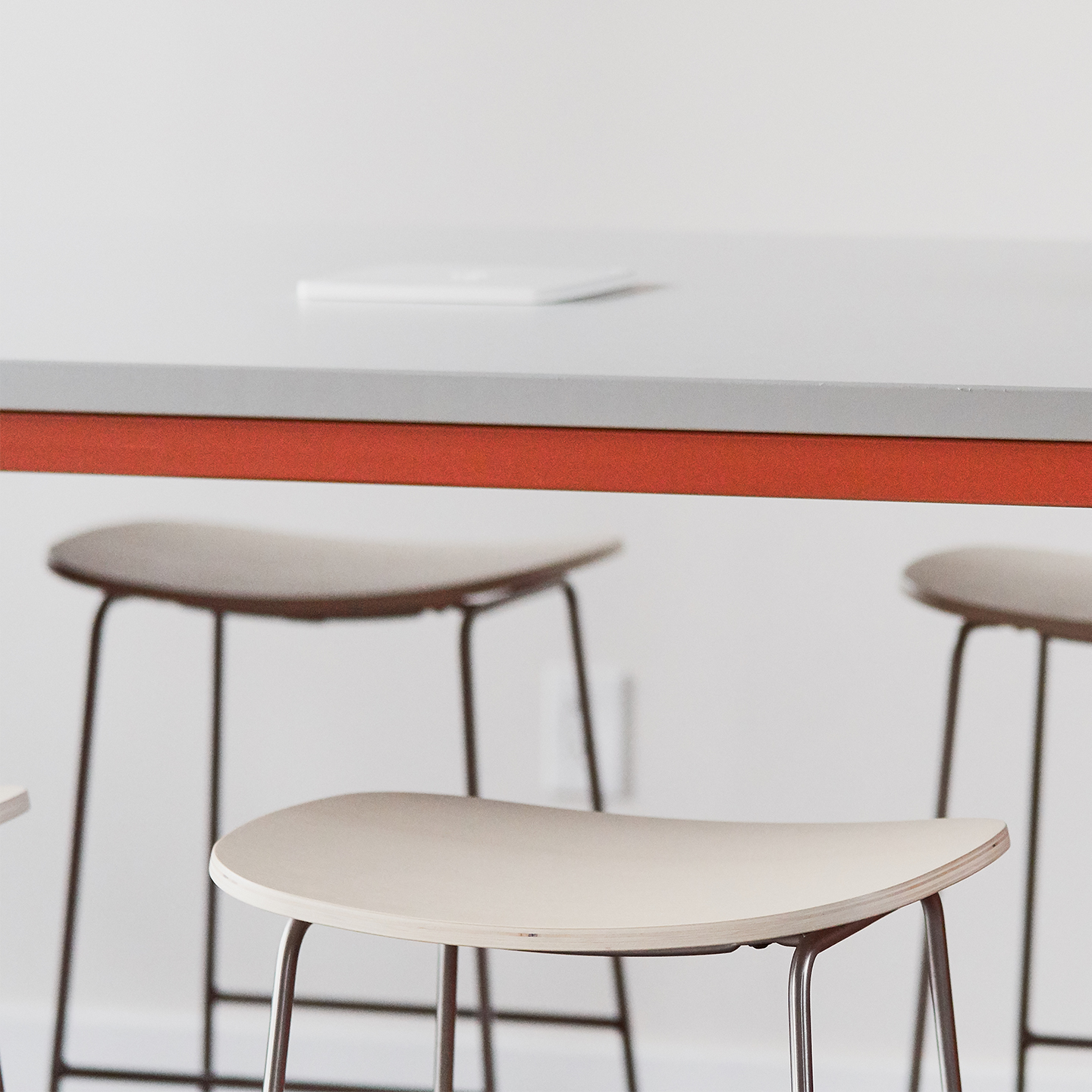 Haworth Collaborative Power Accessories on a tall desk with the charging pad in the center