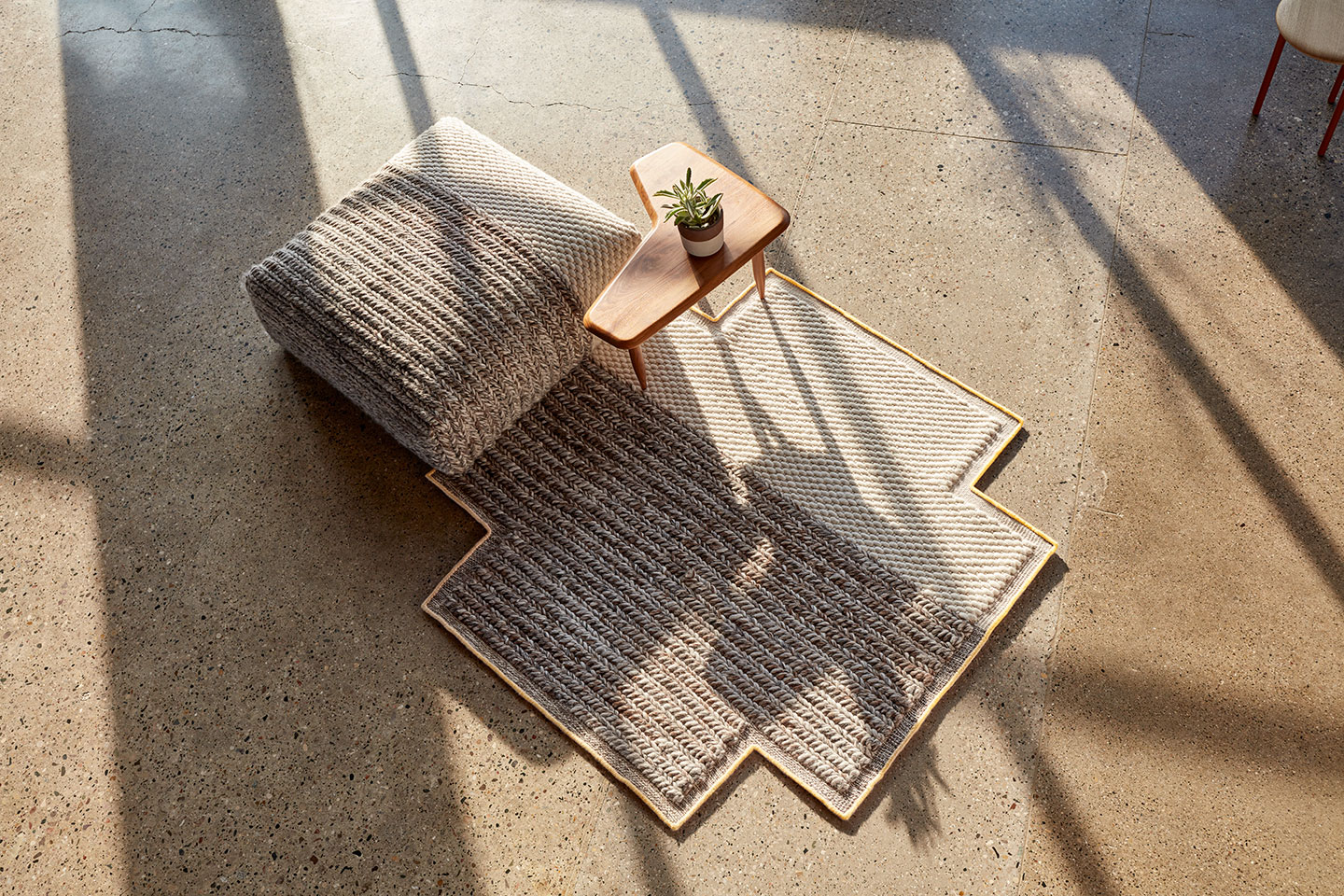 Haworth Mangas Space Rug in grey and white under ottaman in grey and white wool and wood coffee table in open space