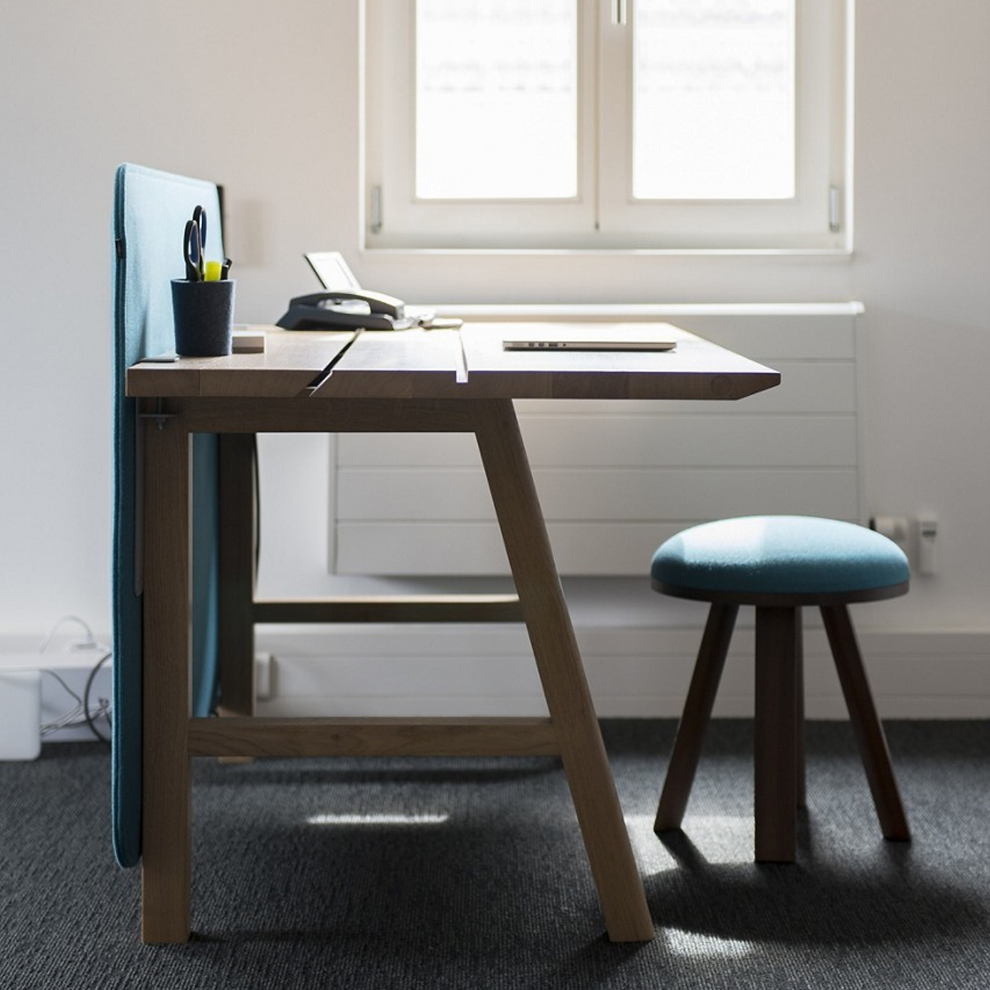 Haworth BuzziFrontDesk Screen in blue color on wood office desk in home office set up
