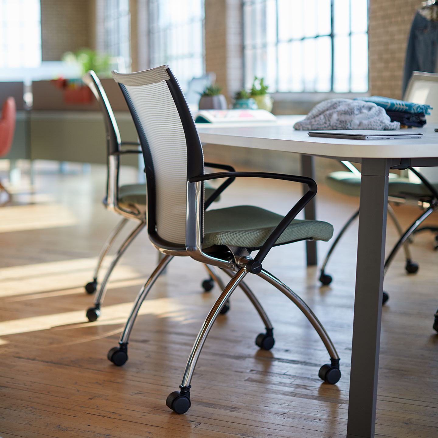 X99 Seminar chair in gray at open workspace